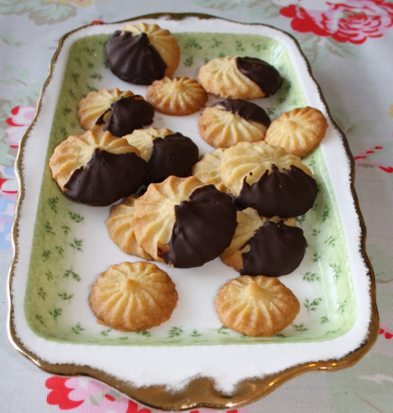 Viennese biscuit dough being piped onto baking sheet