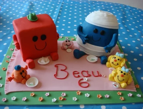 Mr Men and little miss Birthday cake sitting at a picnic