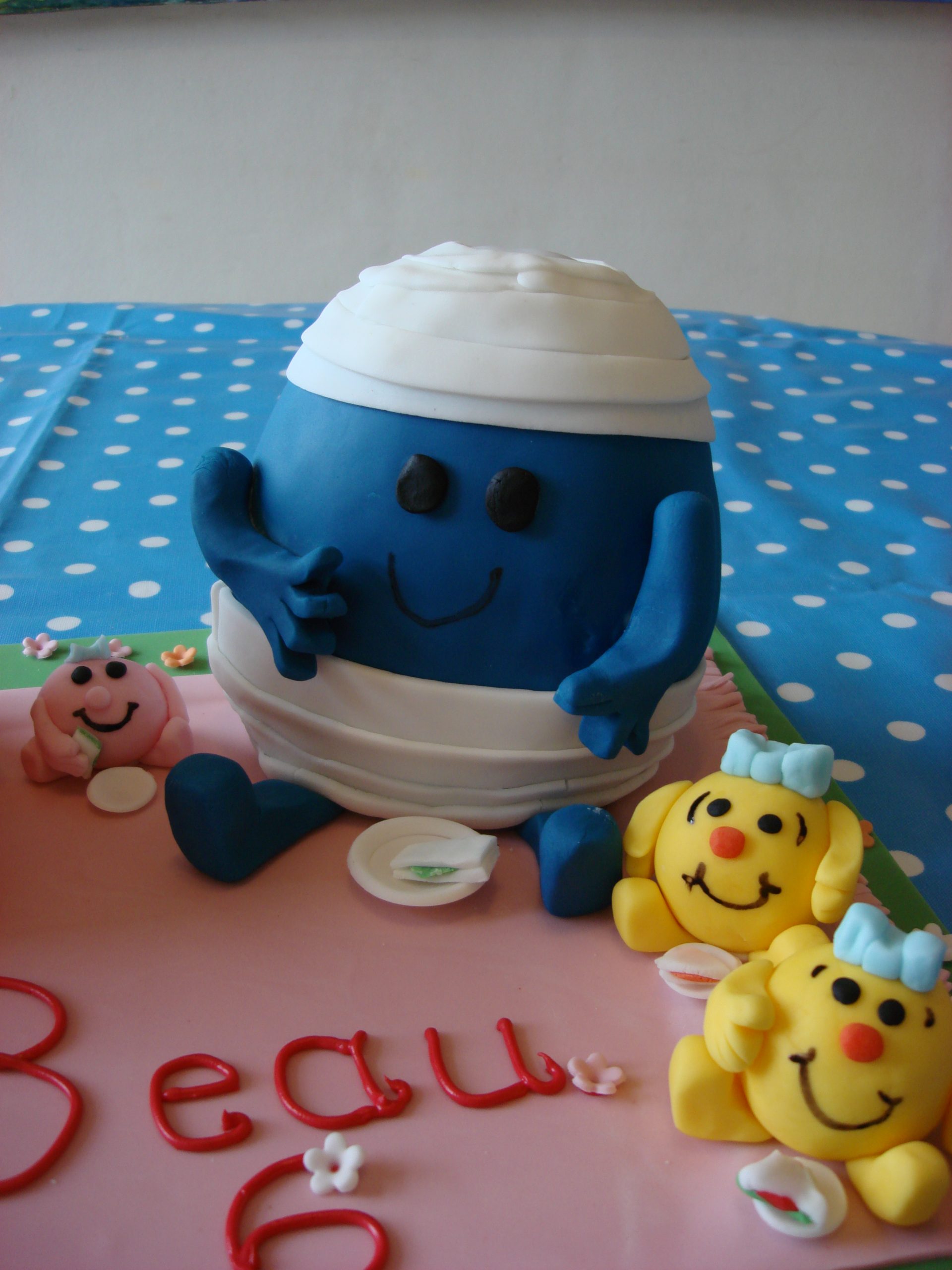 Mr Men and little miss Birthday cake sitting at a picnic