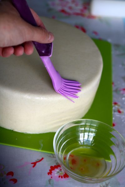 Image: The artistry of sugarpaste application demonstrated in achieving a silky-smooth cake surface.