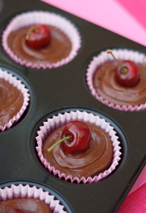 chocolate cupcakes with chocolate ganache and cherries on top