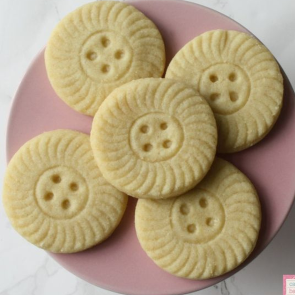 PLate of Almond shortbread recipe made with a cute button cookie cutter