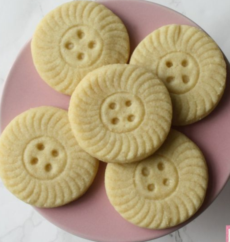 PLate of Almond shortbread recipe made with a cute button cookie cutter