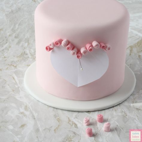 tiny flowers made from sugarpaste on a heart cake 