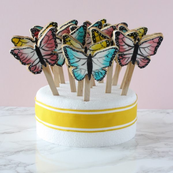 Butterfly biscuits on sticks on display 
