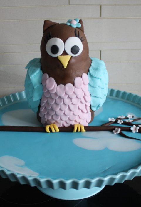 Layered 3d Owl birthday cake sitting on a branch in a blue sky