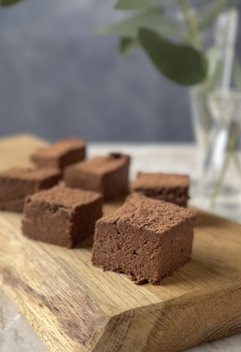 Squares of SUGAR FREE SWEET POTATO ALMOND BROWNIES on a pretty cutting board