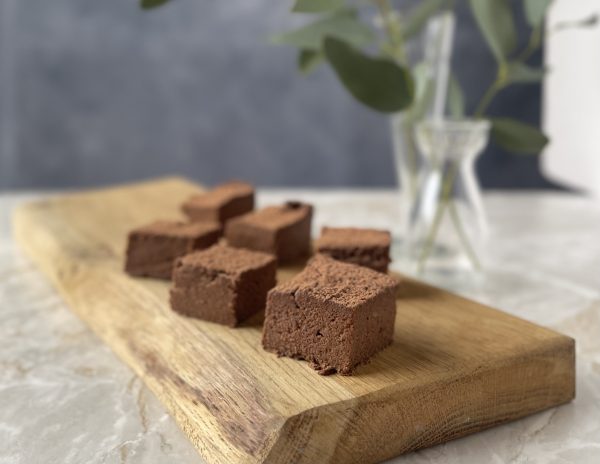 Squares of SUGAR FREE SWEET POTATO ALMOND BROWNIES on a pretty cutting board