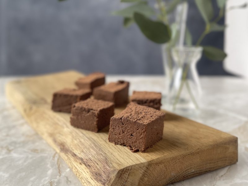 Squares of SUGAR FREE SWEET POTATO ALMOND BROWNIES on a pretty cutting board