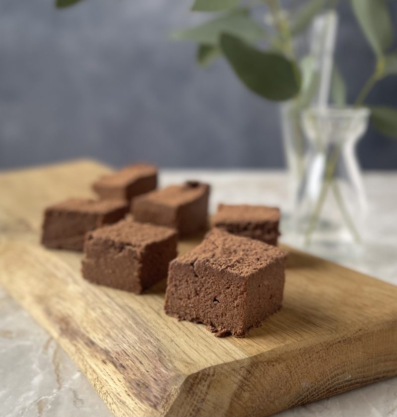 Squares of SUGAR FREE SWEET POTATO ALMOND BROWNIES on a pretty cutting board