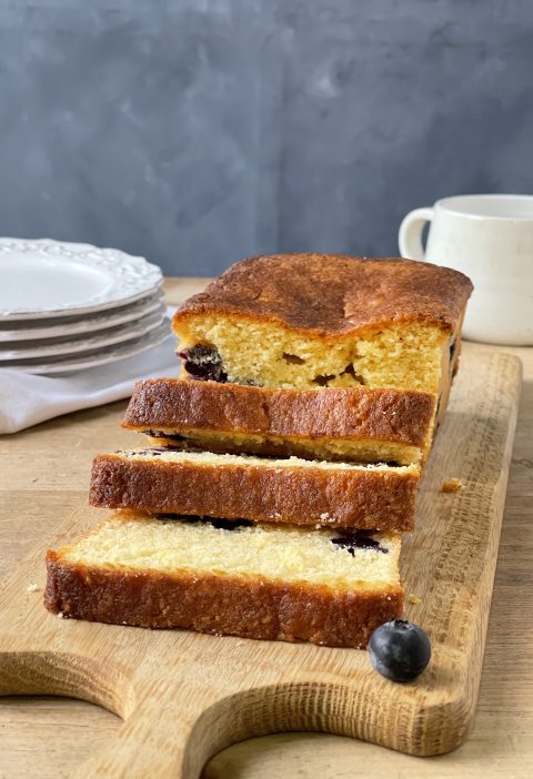 cut blueberry and lemon loaf cake in a lined baking tin