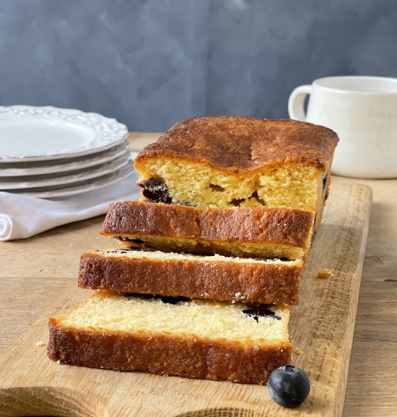 cut blueberry and lemon loaf cake in a lined baking tin