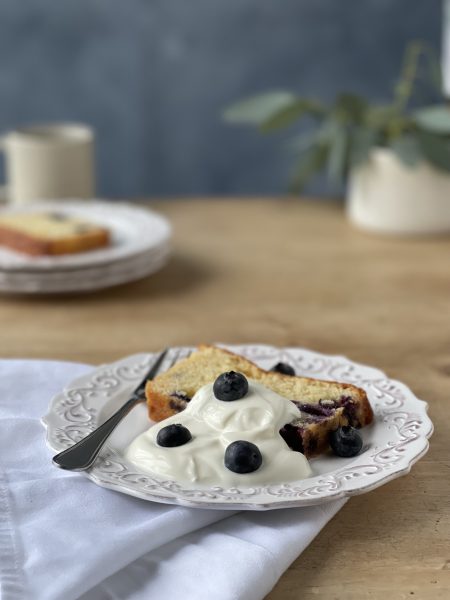 Moist blueberry and lemon loaf cake on a wire cooling rack